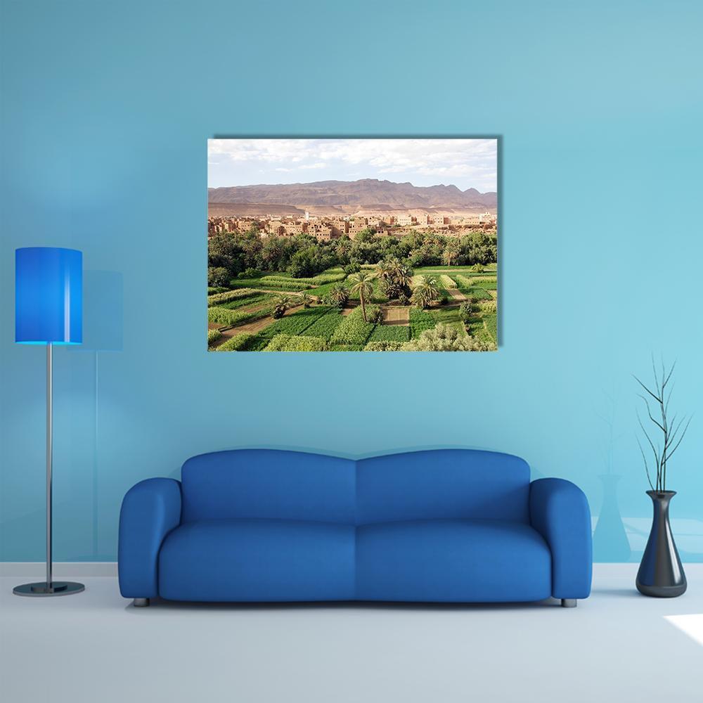 Moroccan Village Oasis Landscape Canvas Wall Art in beige, brown and green, single panel hung on a wall