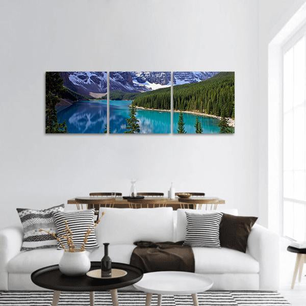 Turquoise Alpine Lake with Mountain Reflections Panoramic Canvas Wall Art in white, green and blue, hung on a wall