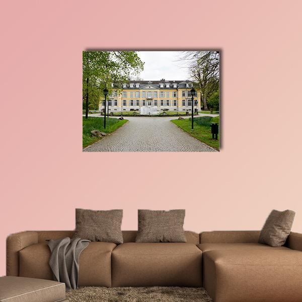 Morsbroich Museum Facade with Fountain Canvas Wall Art in gray, yellow and green, single panel hung on a wall