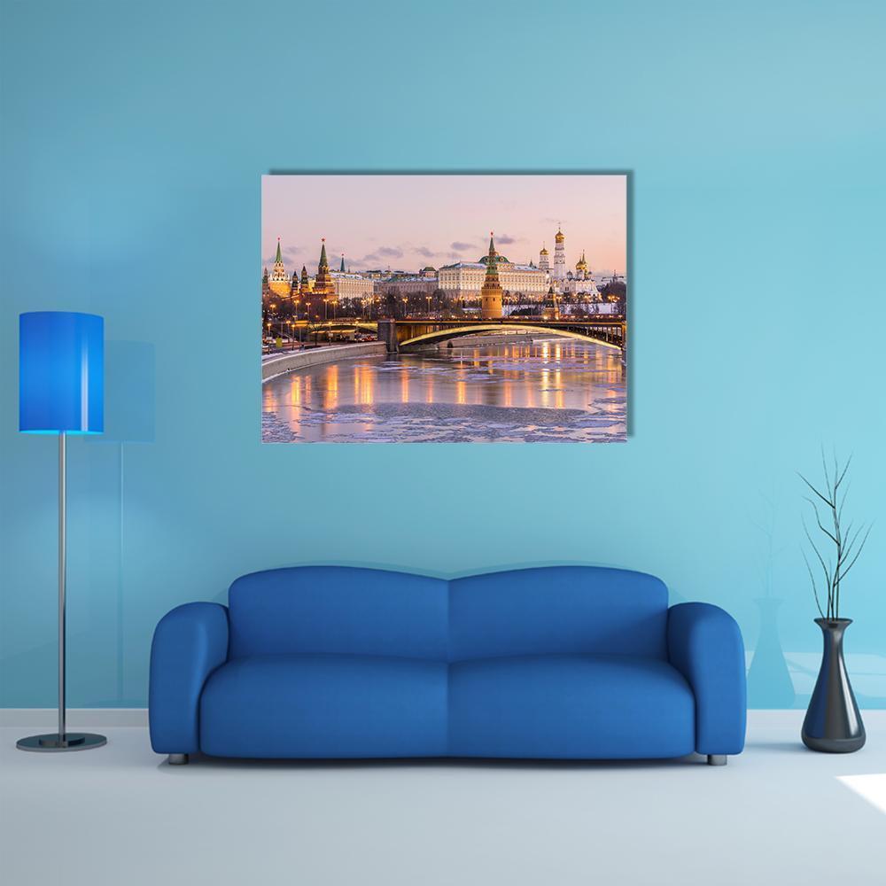Illuminated Moscow Kremlin at Twilight Canvas Wall Art in gold, blue and pink, single panel hung on a wall