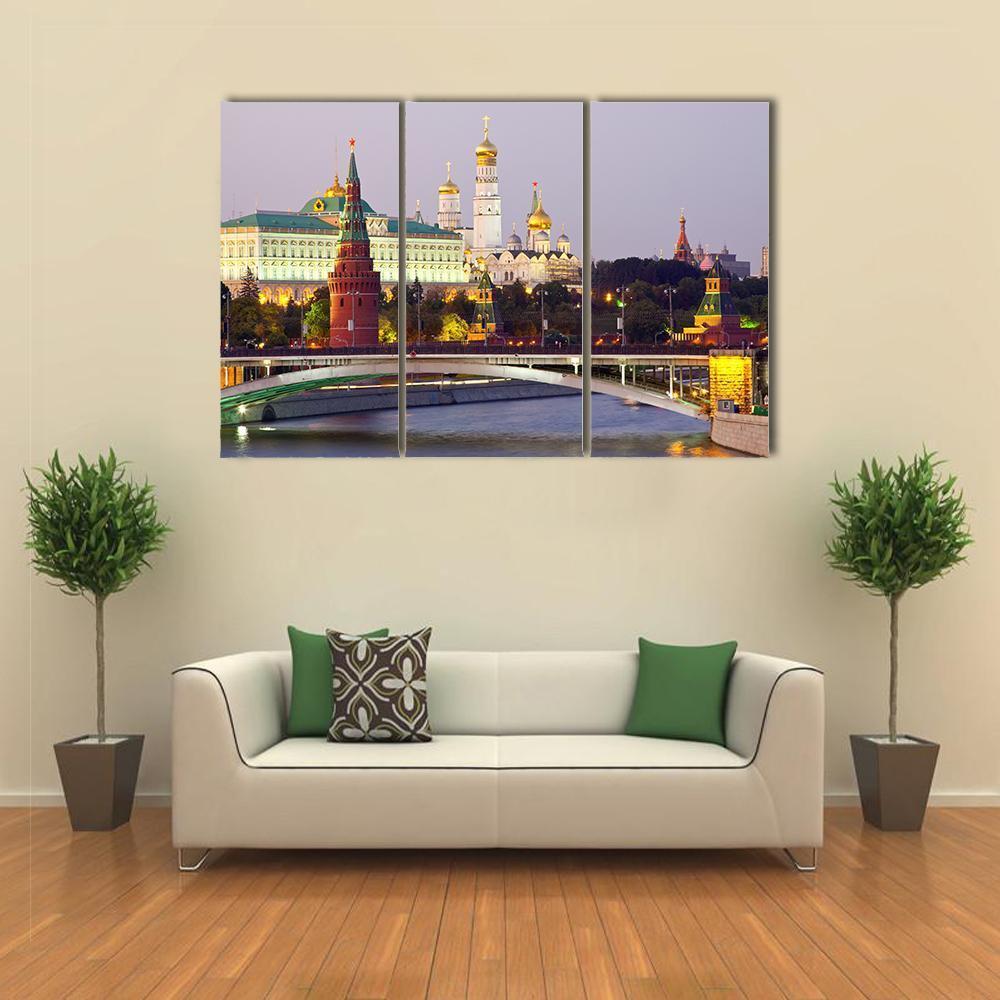 Moscow Kremlin at Dusk Canvas Wall Art in yellow, blue and purple, 3 panel horizontal set hung on a wall