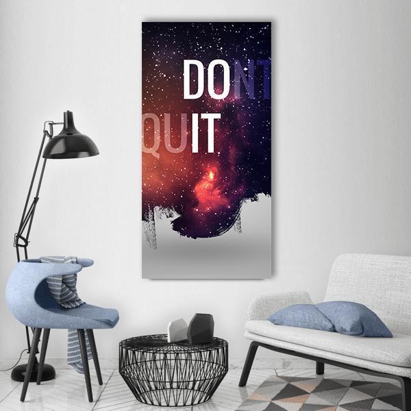 Don't Quit Motivational Nebula Typography Vertical Canvas Wall Art in black, orange and blue, single vertical panel hung on a wall