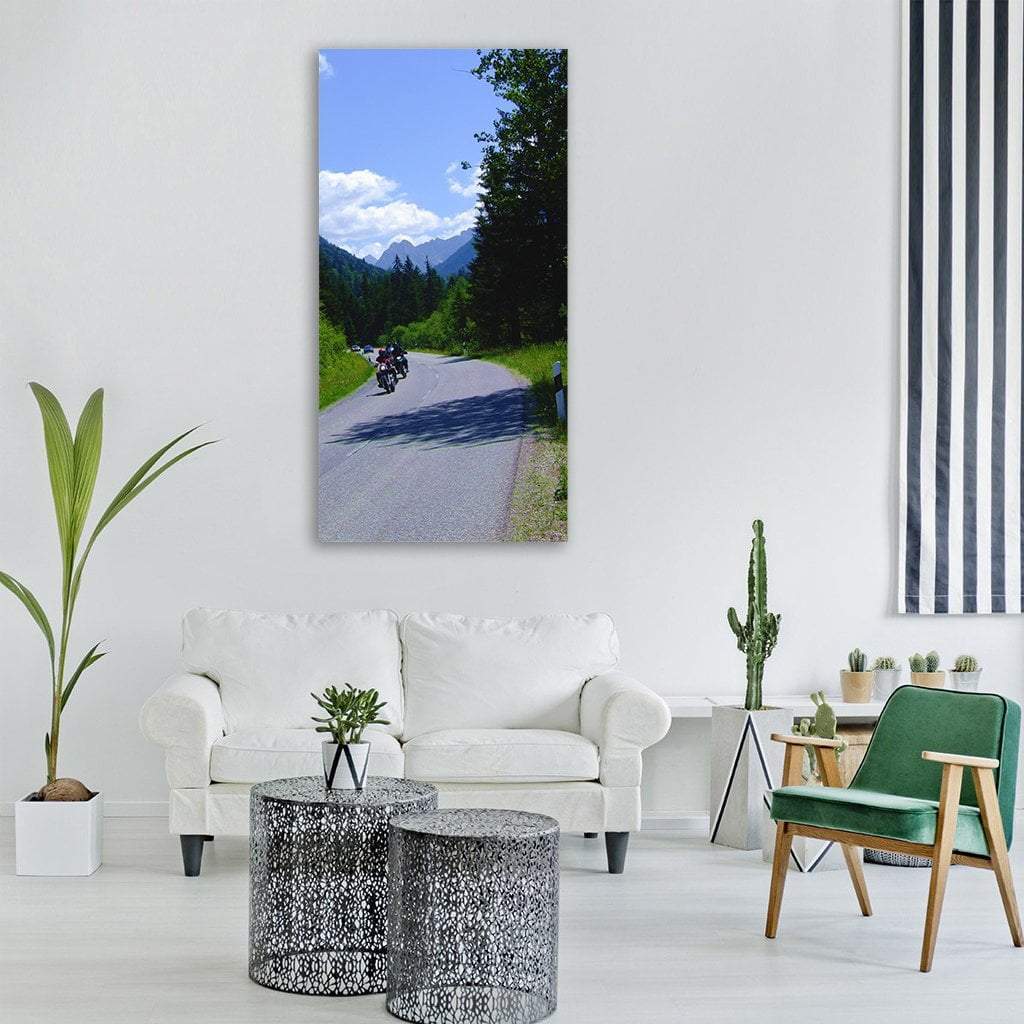 Motorcycles on German Mountain Road Vertical Canvas Wall Art in gray, green and blue, single vertical panel hung on a wall