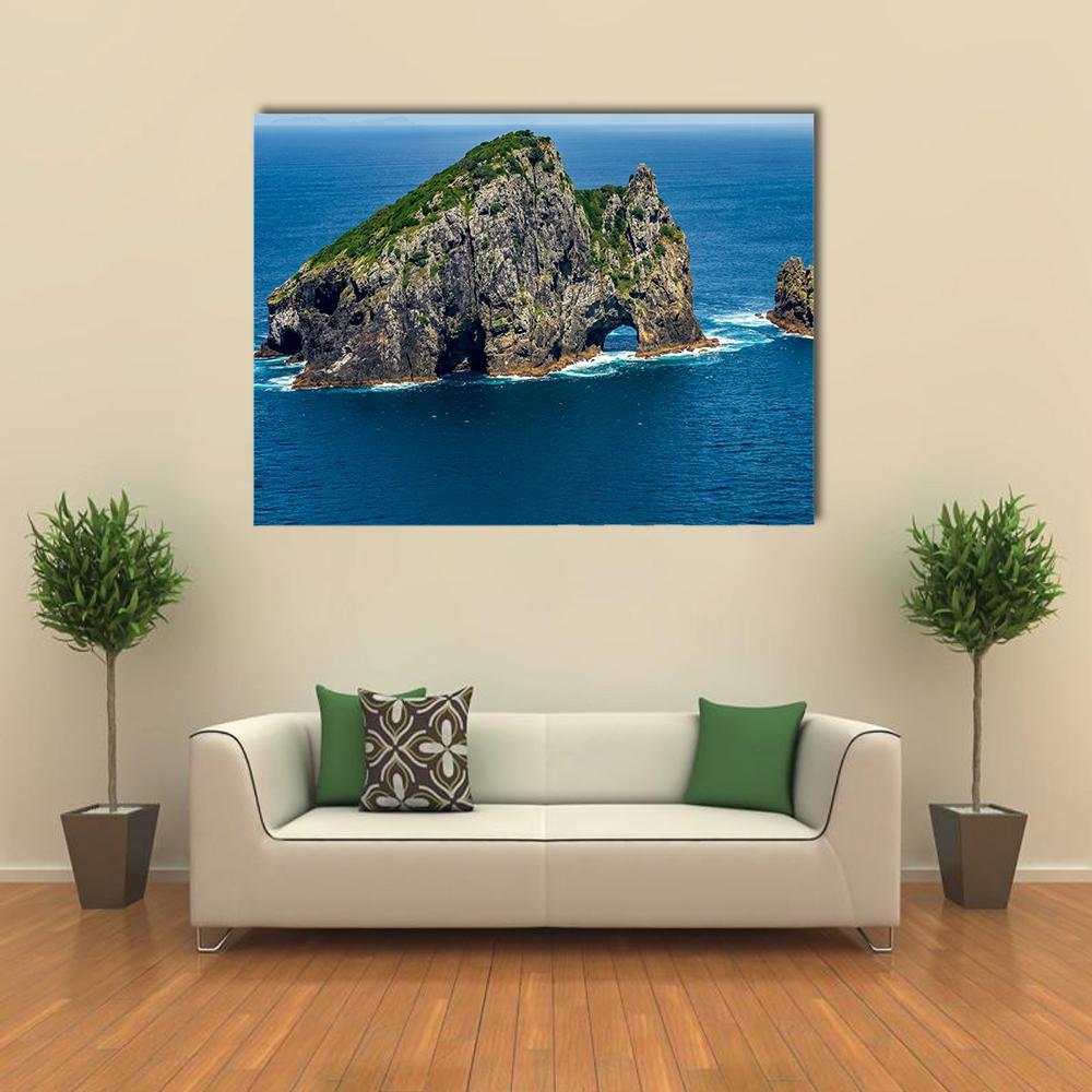 Motukokako Island Sea Arch Canvas Wall Art in gray, green and blue, single panel hung on a wall