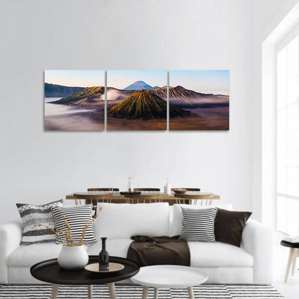 Mount Bromo Morning Mist Panoramic Canvas Wall Art in white, brown and blue, hung on a wall
