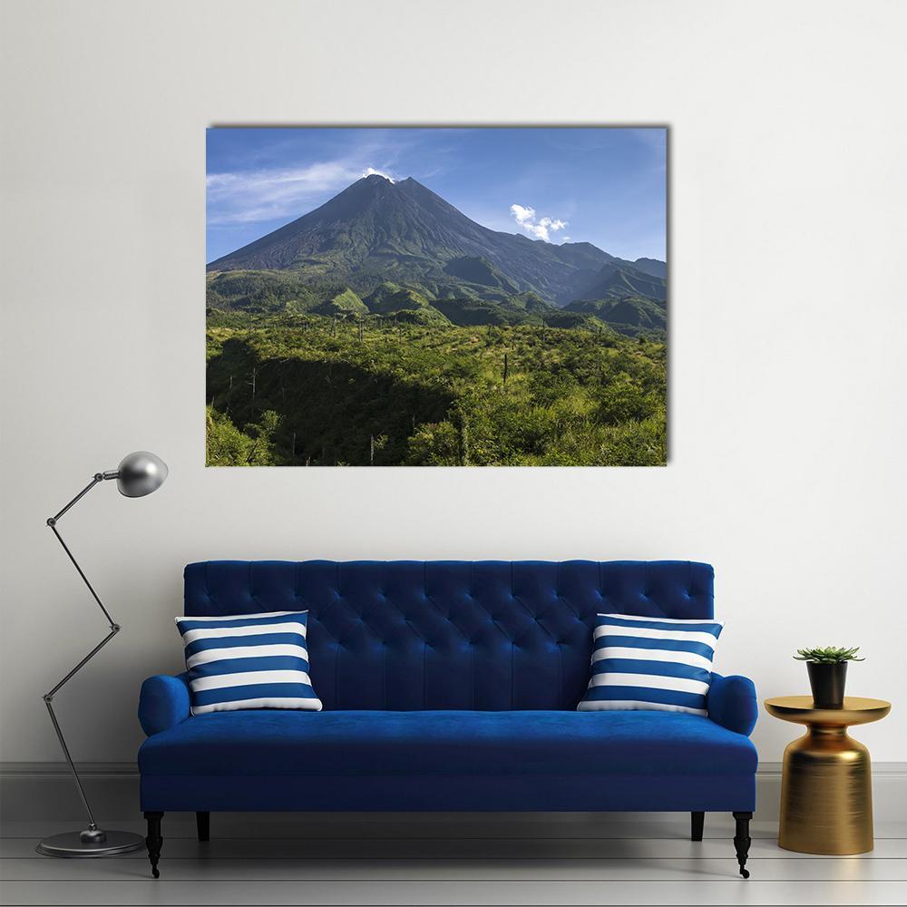 Mount Merapi Volcano Over Lush Green Slopes Canvas Wall Art in gray, green and blue, single panel hung on a wall