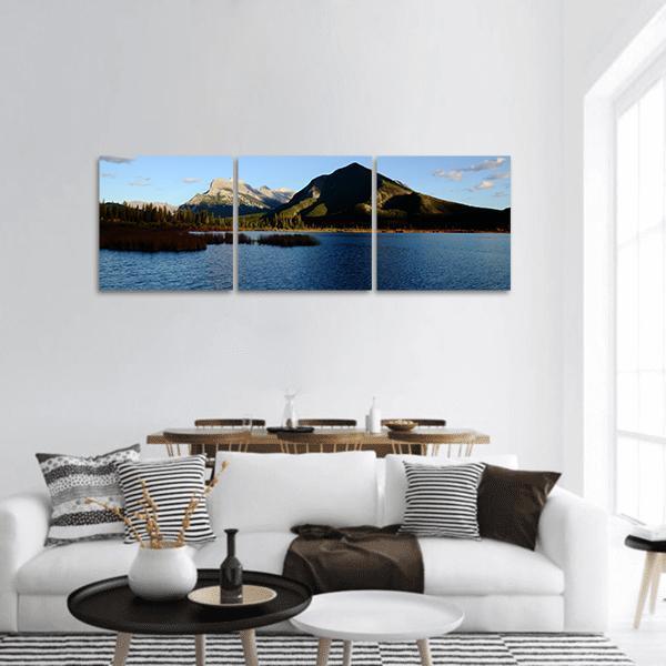 Mount Rundle and Vermilion Lake Panoramic Canvas Wall Art in brown, green and blue, hung on a wall