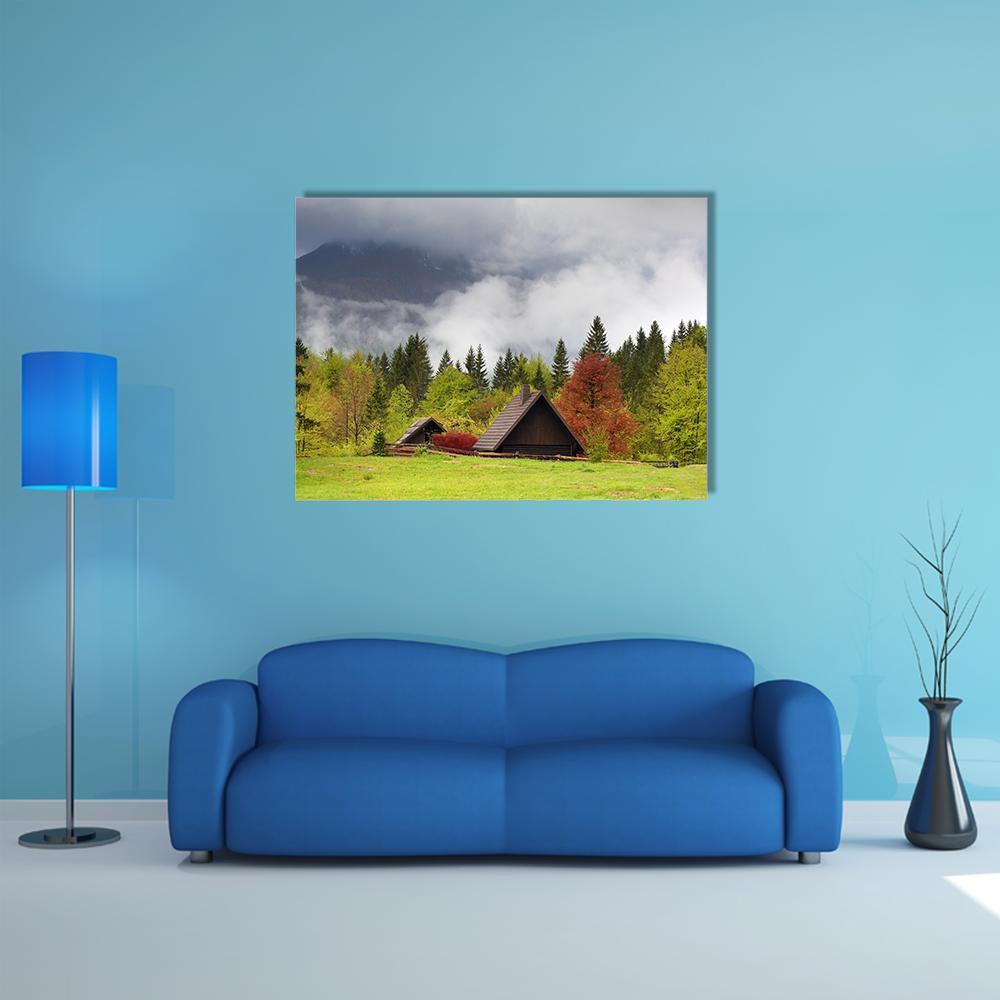 Misty Mountain Cabin Landscape Canvas Wall Art in gray, brown and green, single panel hung on a wall
