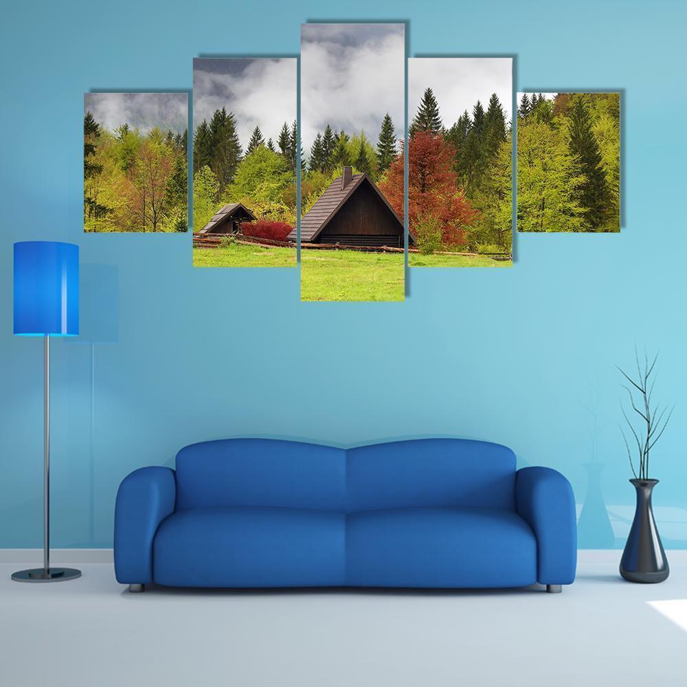 Misty Mountain Cabin Landscape Canvas Wall Art in gray, brown and green, 5 panel Star layout hung on a wall