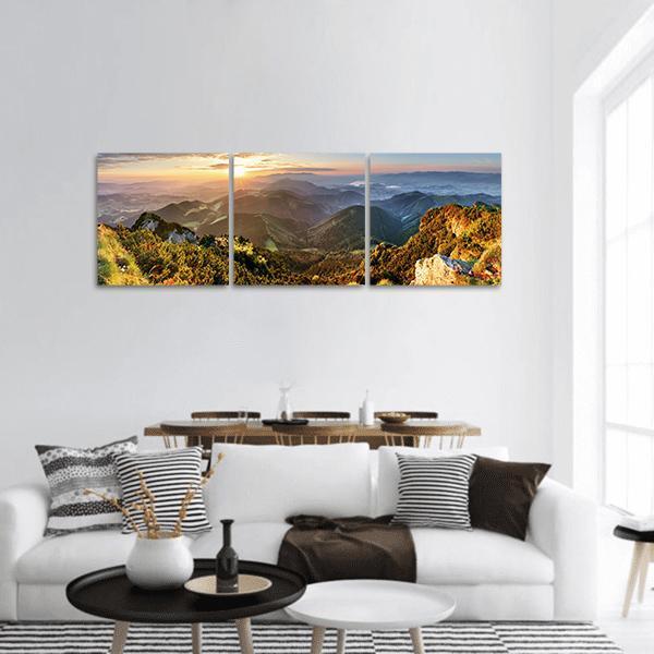Sunlit Mountain Forest Vista Panoramic Canvas Wall Art in yellow, green and blue, hung on a wall