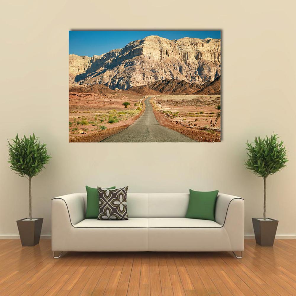 Timna Park Desert Road Landscape Canvas Wall Art in beige, brown and blue, single panel hung on a wall