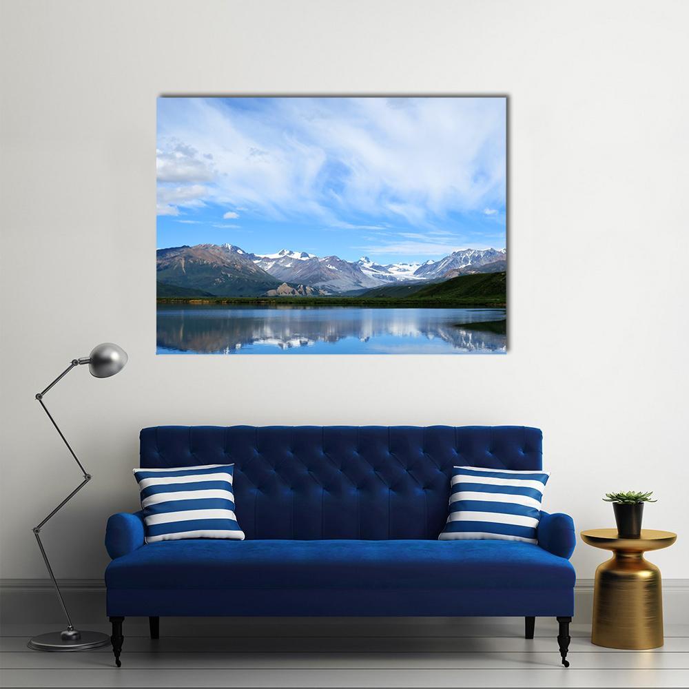 Snow-capped Mountain Lake Canvas Wall Art in white, gray and blue, single panel hung on a wall