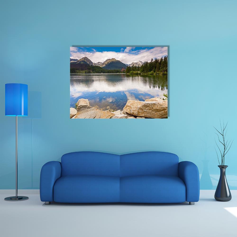 Mountain Lake Reflection with Boulders Canvas Wall Art in beige, green and blue, single panel hung on a wall
