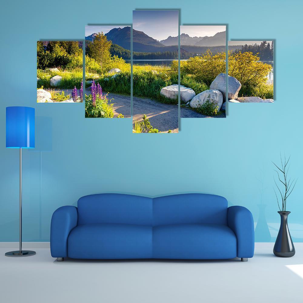 Mountain Lake with Purple Lupines Canvas Wall Art in green, blue and purple, 5 panel Star layout hung on a wall