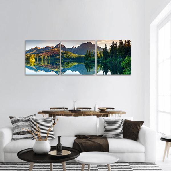 Alpine Lake with Mountain Reflection Panoramic Canvas Wall Art in green and blue, hung on a wall