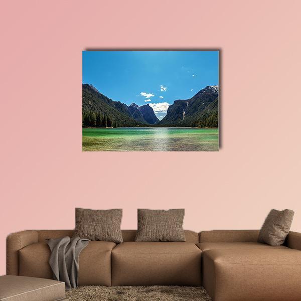 Turquoise Lake with Tree-covered Mountains Canvas Wall Art in gray, green and blue, single panel hung on a wall