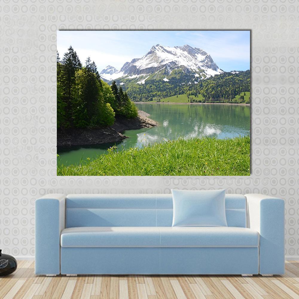 Mountain Lake Scene Canvas Wall Art in white, green and blue, single panel hung on a wall
