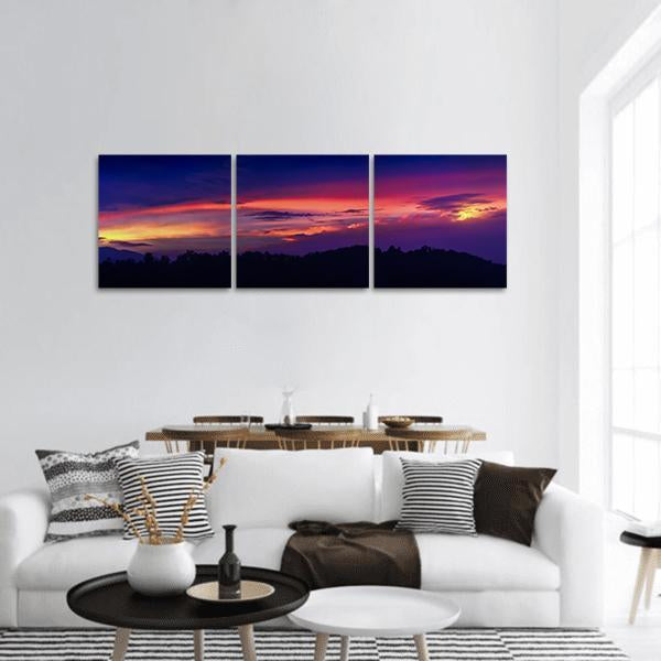 Mountain at Twilight Panoramic Canvas Wall Art in orange, blue and purple, hung on a wall