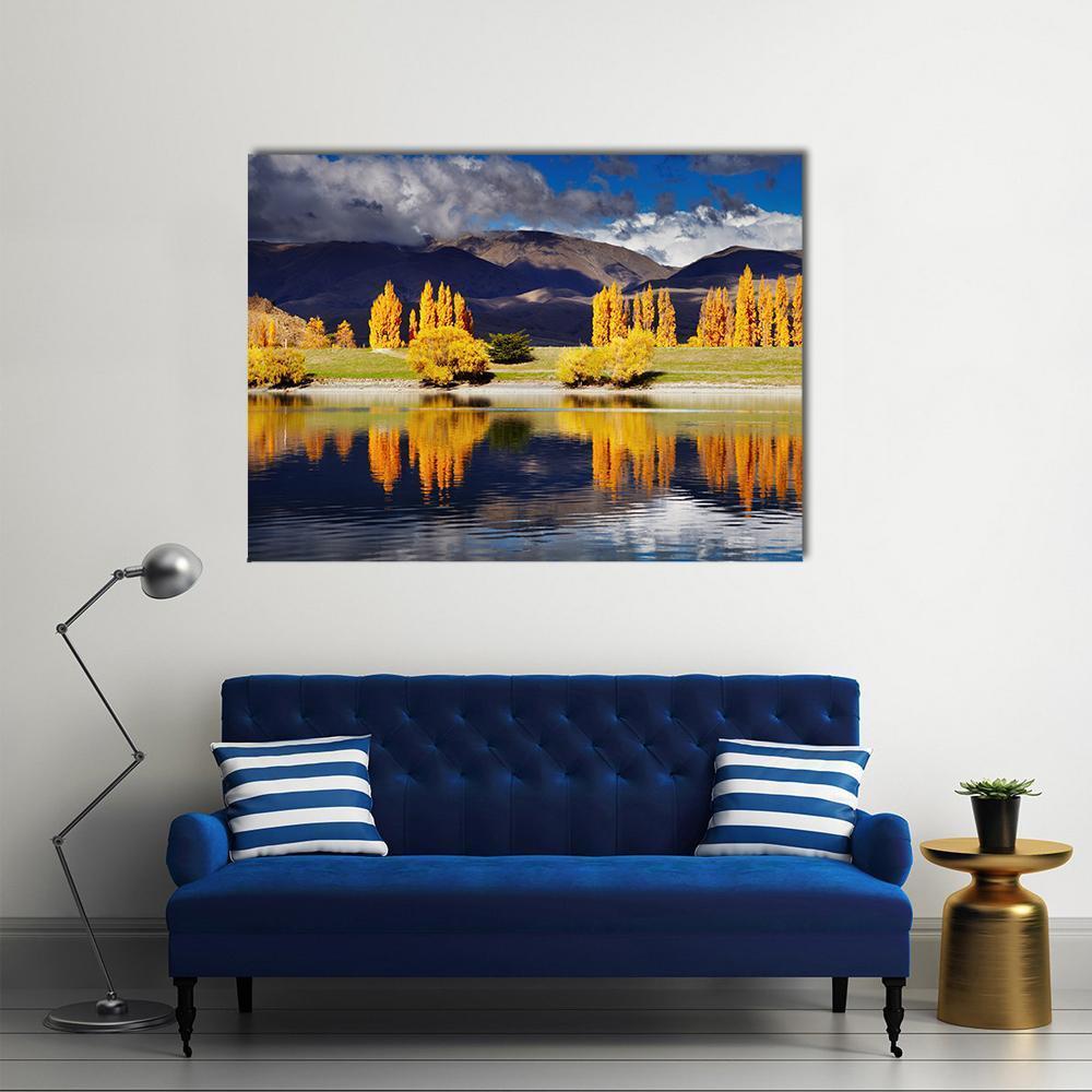 Autumn Lake with Yellow Trees and Mountains Canvas Wall Art in brown, yellow and blue, single panel hung on a wall