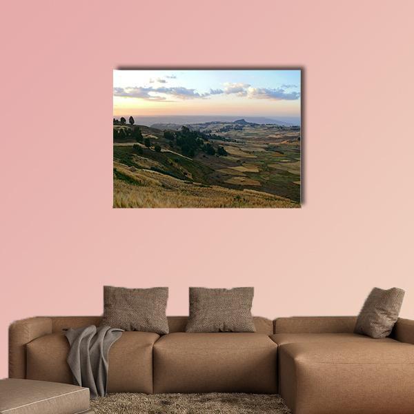 Ethiopian Mountain Farmland at Sunset Canvas Wall Art in brown, yellow and blue, single panel hung on a wall