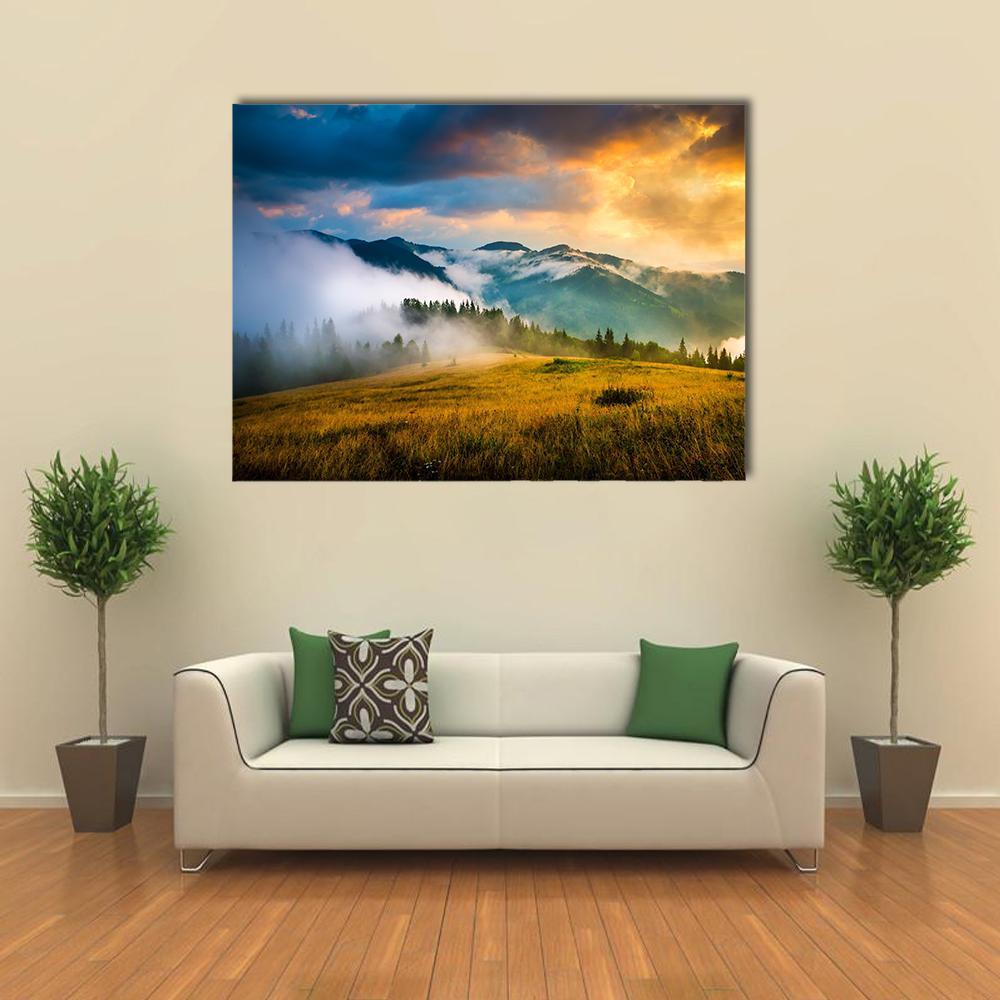 Misty Mountain Range at Golden Dawn Canvas Wall Art in orange, yellow and blue, single panel hung on a wall