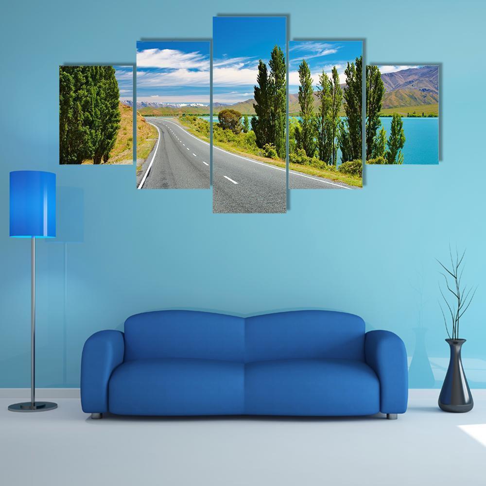 Lakeside Road with Distant Mountains Canvas Wall Art in gray, green and blue, 5 panel Star layout hung on a wall