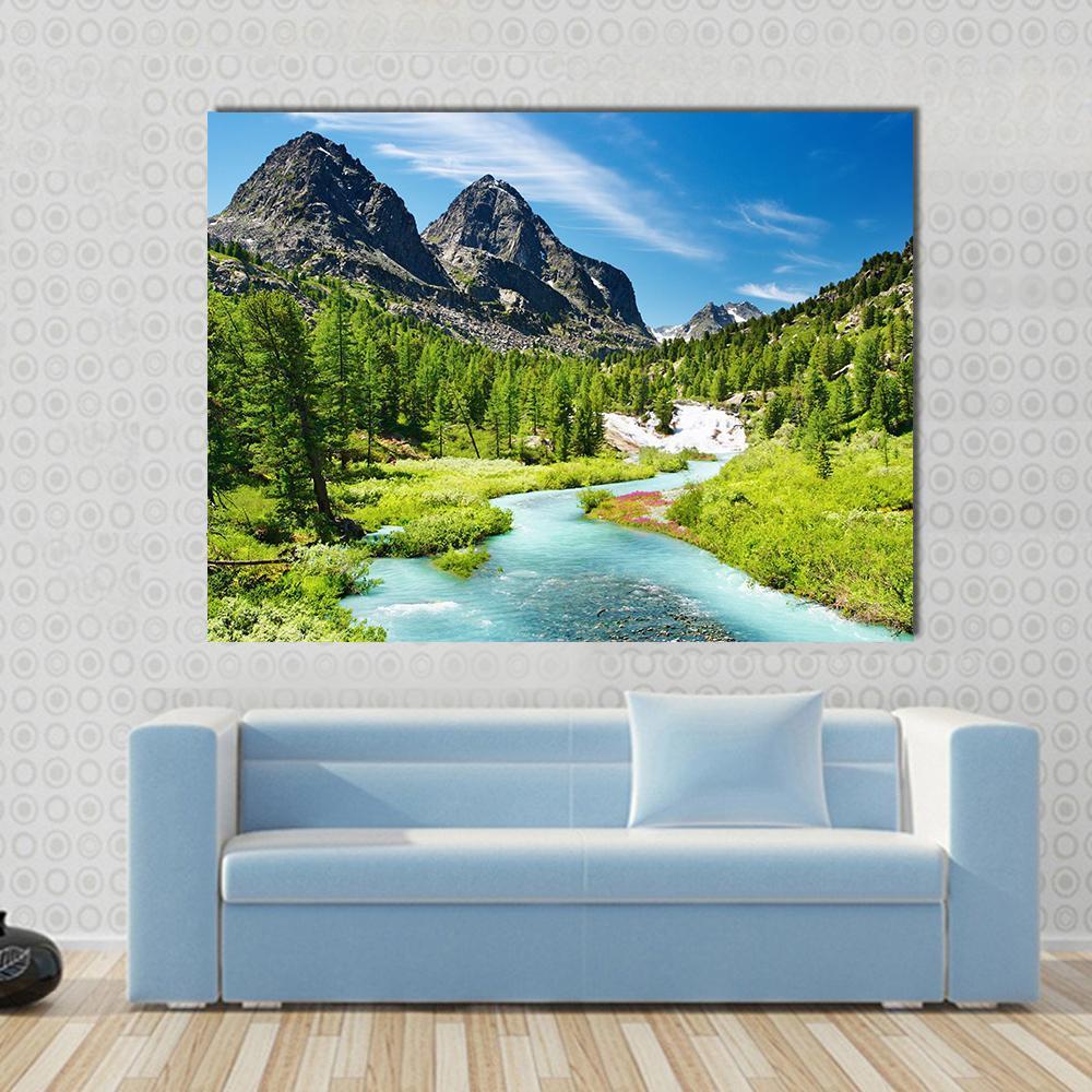 Winding Turquoise River and Mountain Peaks Canvas Wall Art in gray, green and blue, single panel hung on a wall
