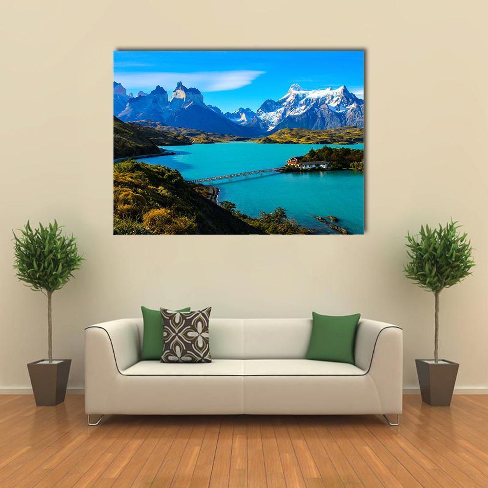 Turquoise Lake Beneath Snow-capped Mountains Canvas Wall Art in white, green and blue, single panel hung on a wall