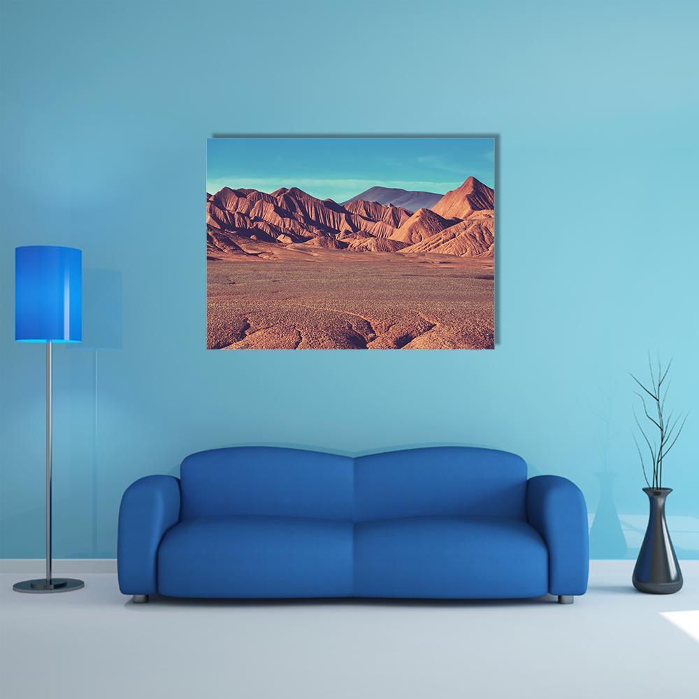 La Puna Mountain Plateau Canvas Wall Art in brown, orange and blue, single panel hung on a wall