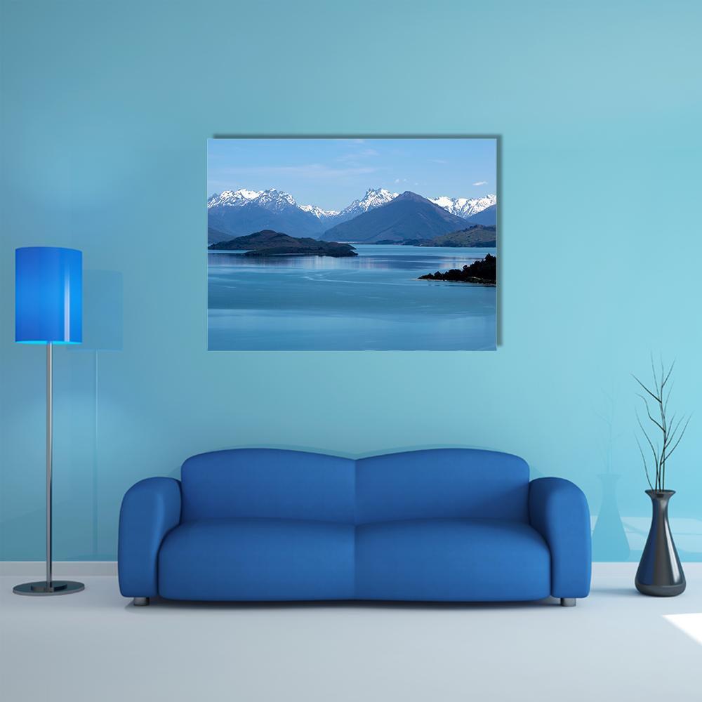 Snow-capped Mountains Over Calm Lake Canvas Wall Art in white, blue and navy, single panel hung on a wall