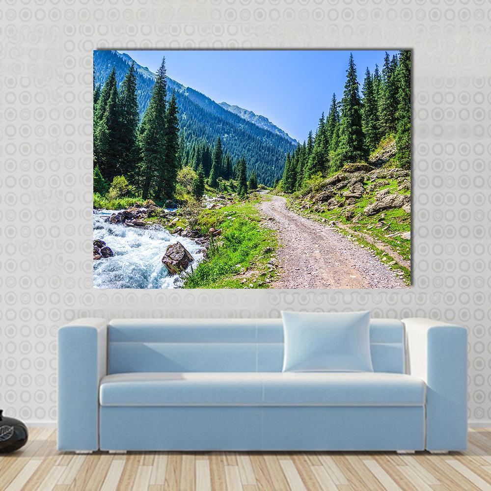 Mountain River Road Canvas Wall Art in brown, green and blue, single panel hung on a wall