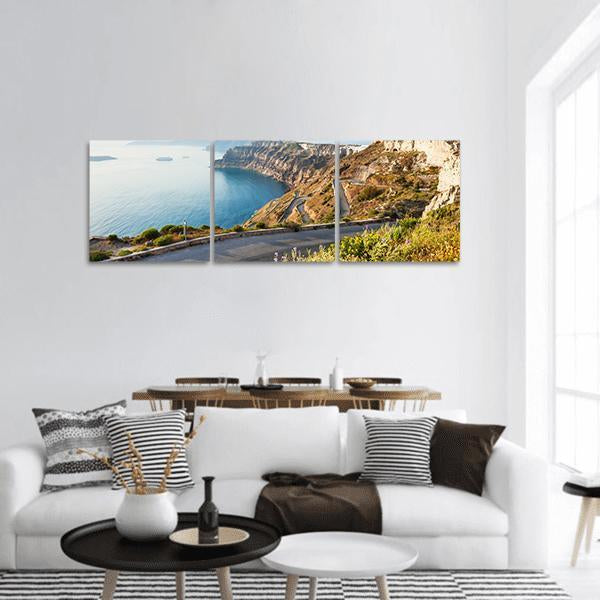 Mountain Road to Santorini Panoramic Canvas Wall Art in beige, brown and blue, hung on a wall
