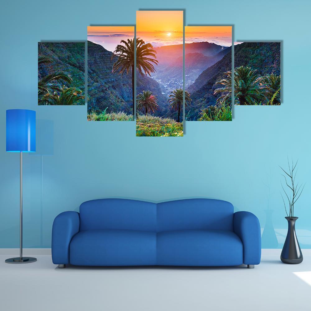 Golden Sun Over Mountain Valley Canvas Wall Art in orange, green and blue, 5 panel Star layout hung on a wall