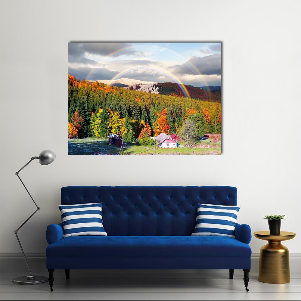 Carpathian Mountain Village with Double Rainbow Canvas Wall Art in orange, yellow and green, single panel hung on a wall