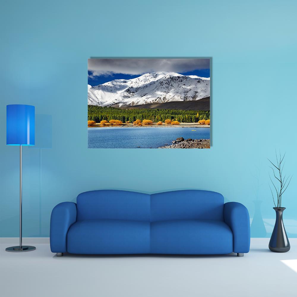 Snow-capped Mountain Over Lake Tekapo Canvas Wall Art in white, green and blue, single panel hung on a wall