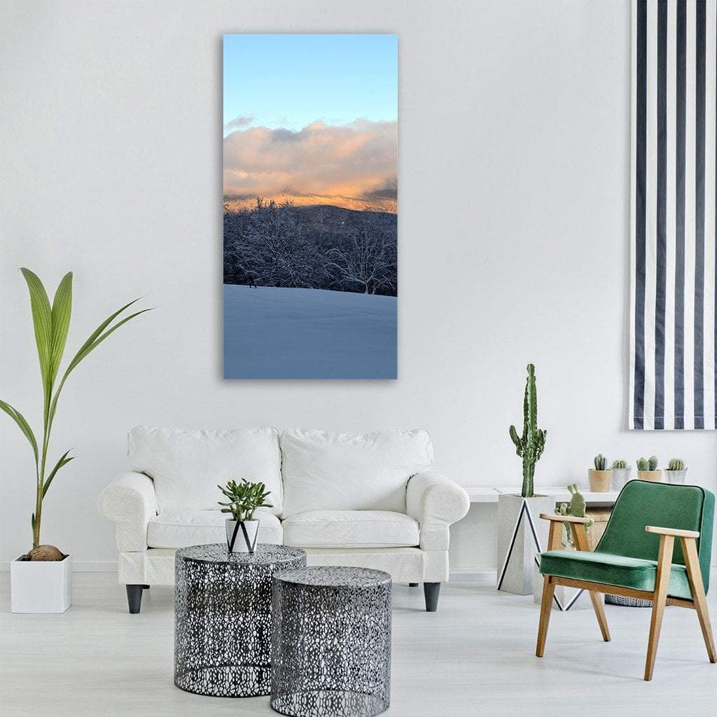 Snowy Mountain with Trees Vertical Canvas Wall Art in white, gray and blue, single vertical panel hung on a wall