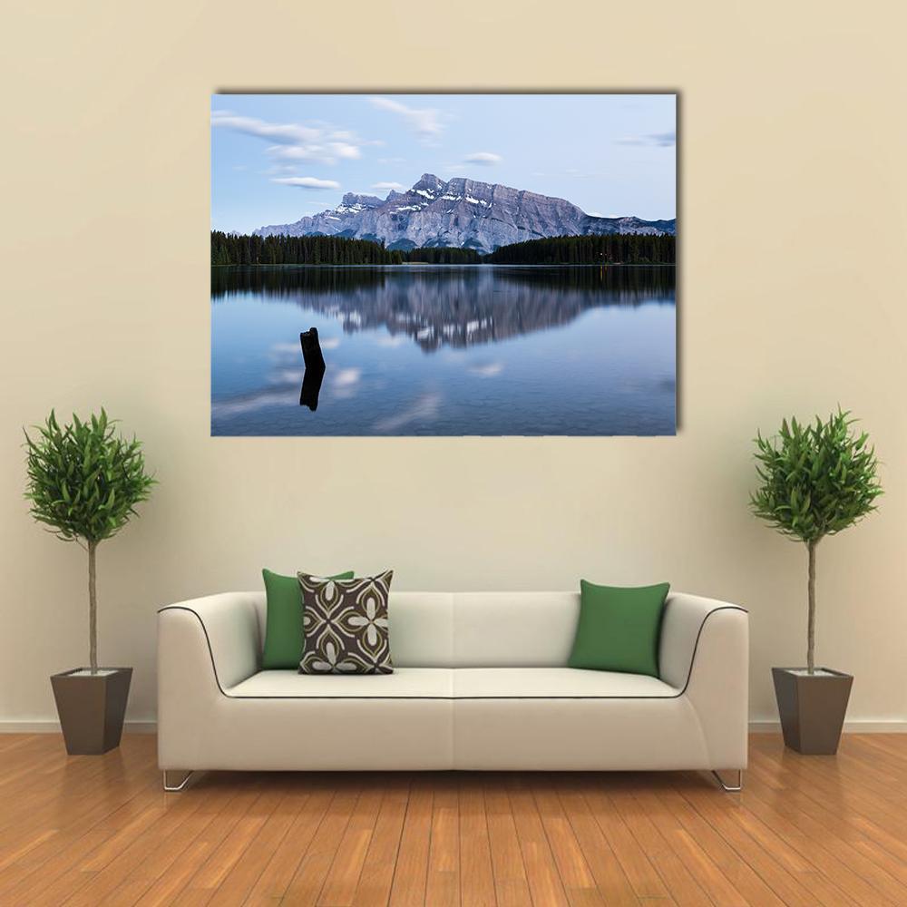 Two Jack Lake with Snow-capped Mountains Canvas Wall Art in white, gray and blue, single panel hung on a wall