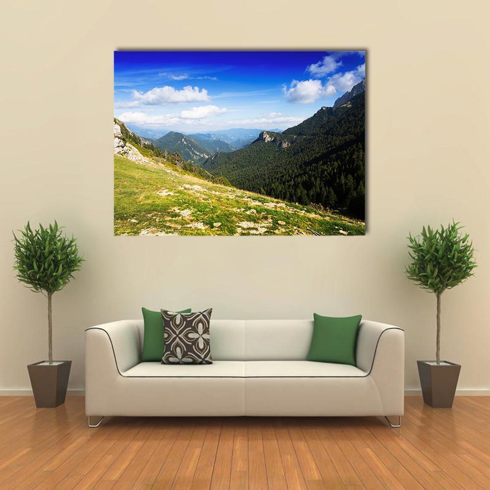 August Mountain Landscape Canvas Wall Art in white, green and blue, single panel hung on a wall