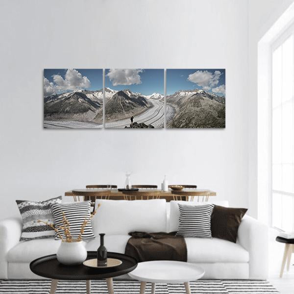 Winding Glacier Through Snow-capped Mountains Panoramic Canvas Wall Art in white, gray and blue, hung on a wall