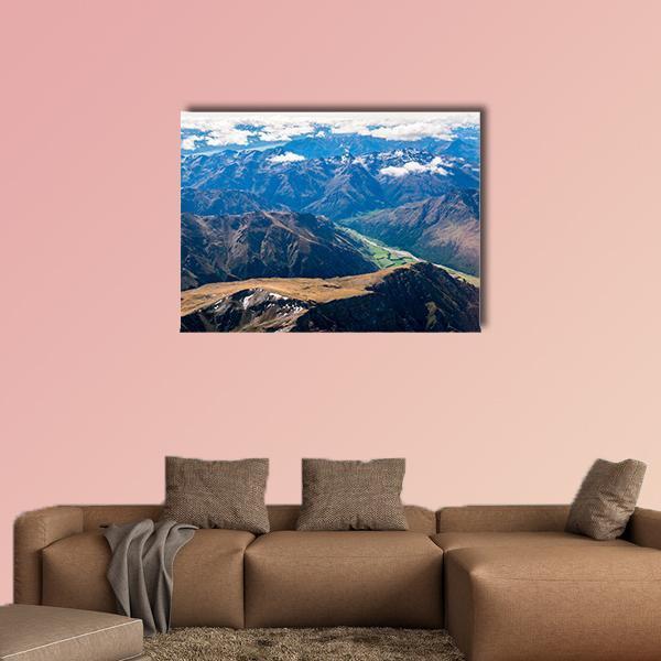 Aerial Mountain Valley with Winding River Canvas Wall Art in white, brown and blue, single panel hung on a wall