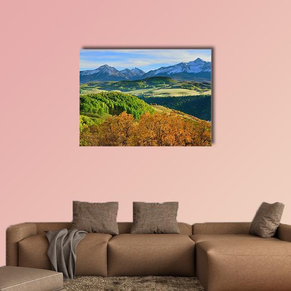 Autumn Mountain Valley with Fog Canvas Wall Art in orange, green and blue, single panel hung on a wall