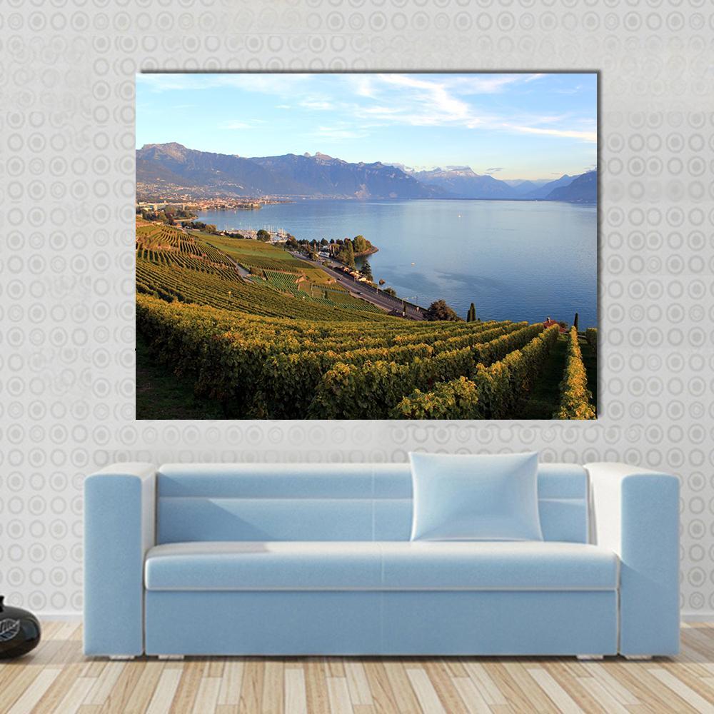 Mountains on Lake Geneva Canvas Wall Art in yellow, green and blue, single panel hung on a wall