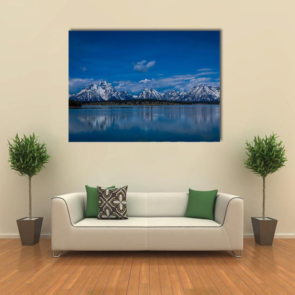 Snow-capped Mountains Over Calm Lake Canvas Wall Art in white and blue, single panel hung on a wall