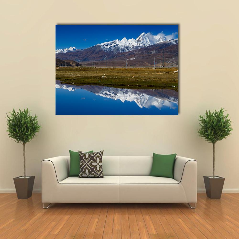 Snow-capped Mountains Reflected in Lake Canvas Wall Art in white, brown and blue, single panel hung on a wall