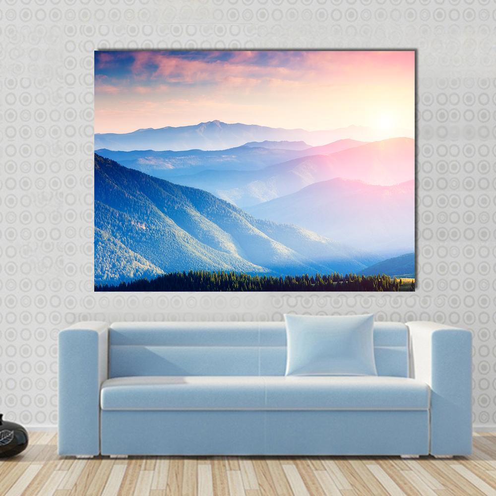 Mountains with Sunny Beams Canvas Wall Art in yellow, blue and pink, single panel hung on a wall