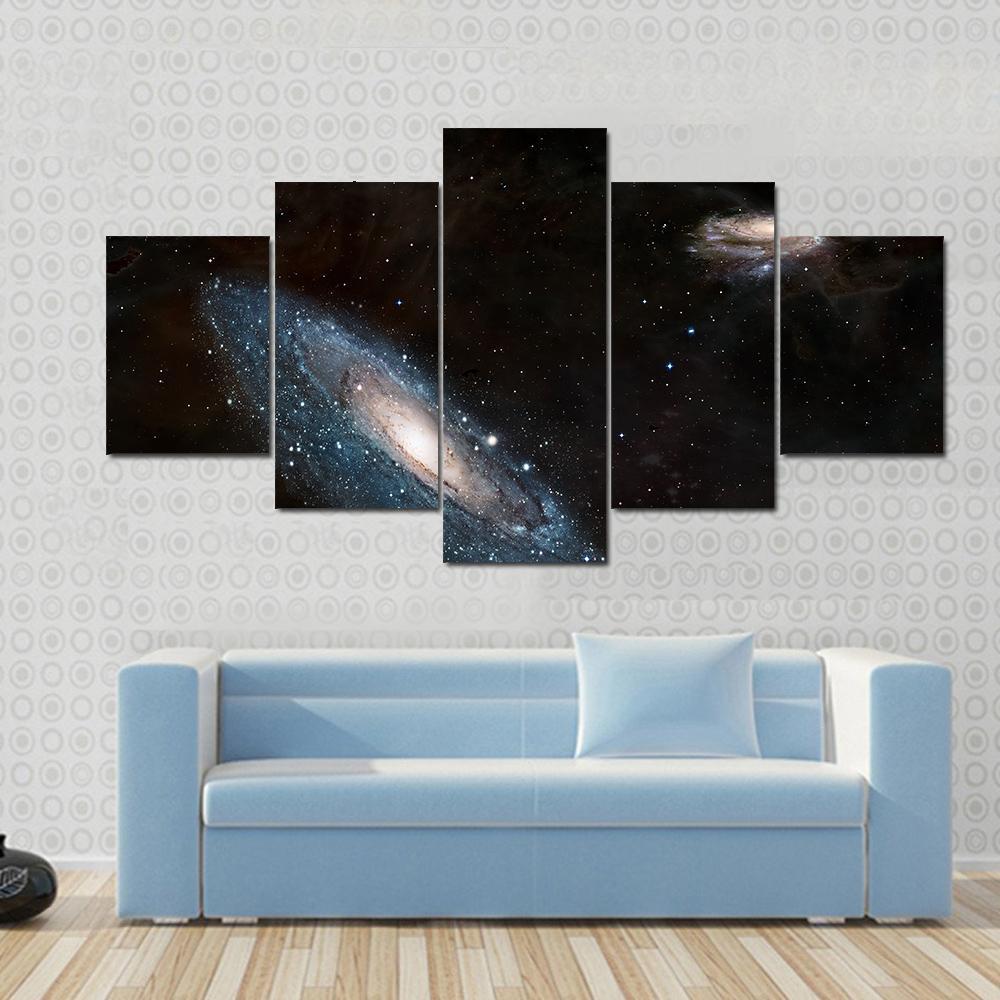 Andromeda Galaxy and Milky Way Canvas Wall Art in black and blue, 5 panel Star layout hung on a wall