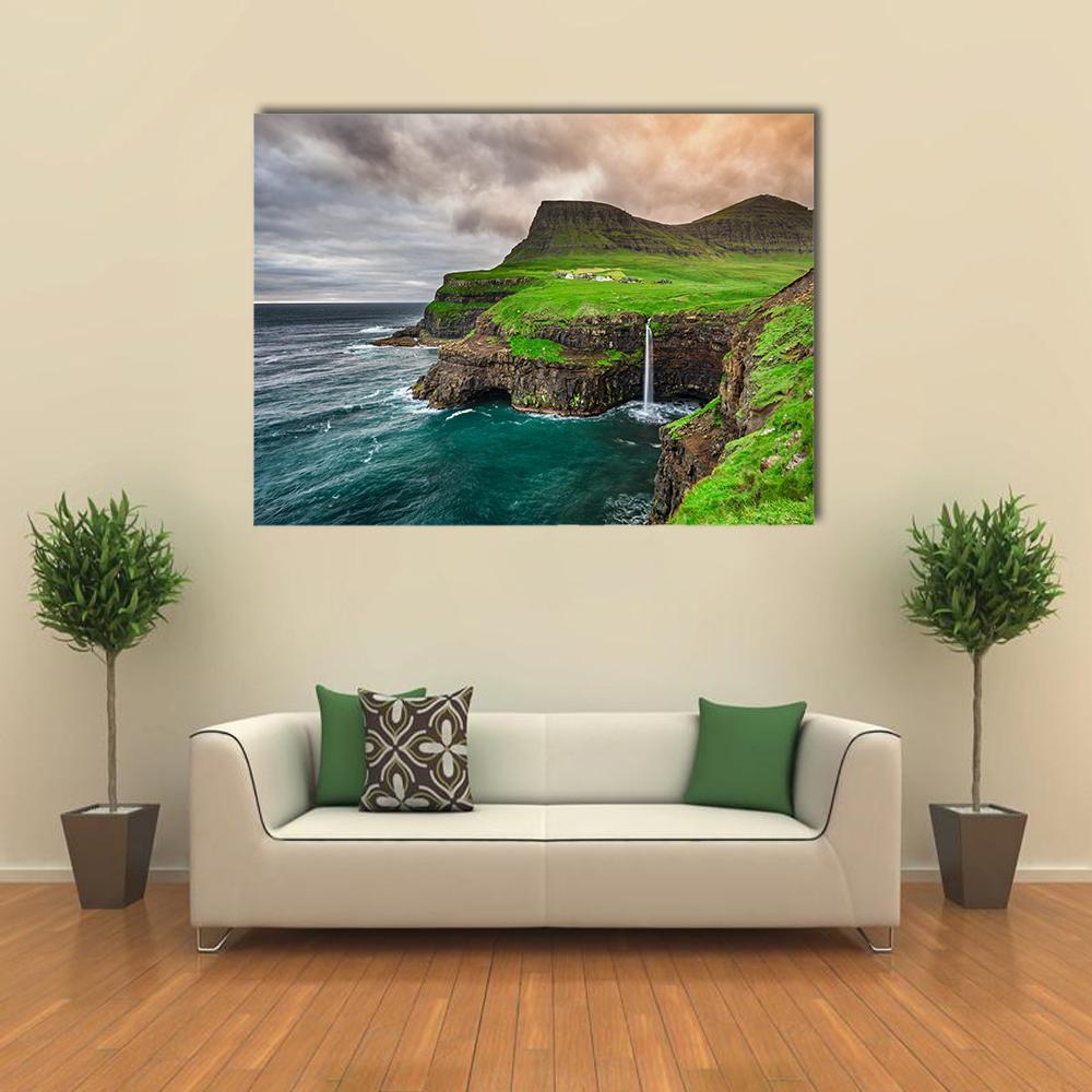 Mulafossur Waterfall and Coastal Village Canvas Wall Art in gray, green and blue, single panel hung on a wall