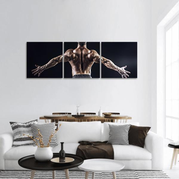 Bodybuilder with Outstretched Arms Panoramic Canvas Wall Art in black and brown, hung on a wall