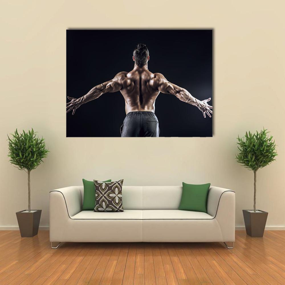 Muscular Man with Outspread Arms Canvas Wall Art in black and brown, single panel hung on a wall