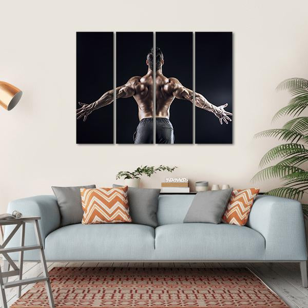 Muscular Man with Outspread Arms Canvas Wall Art in black and brown, hung on a wall